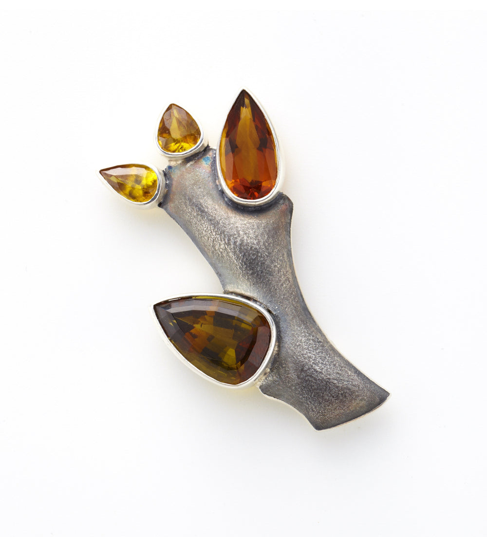silver brooch with two sphene, citrine and tourmaline